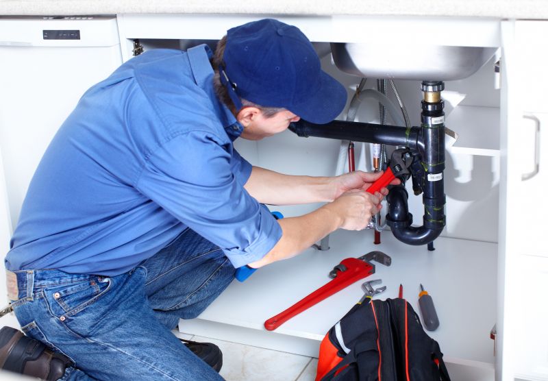 Plumber working on a sink